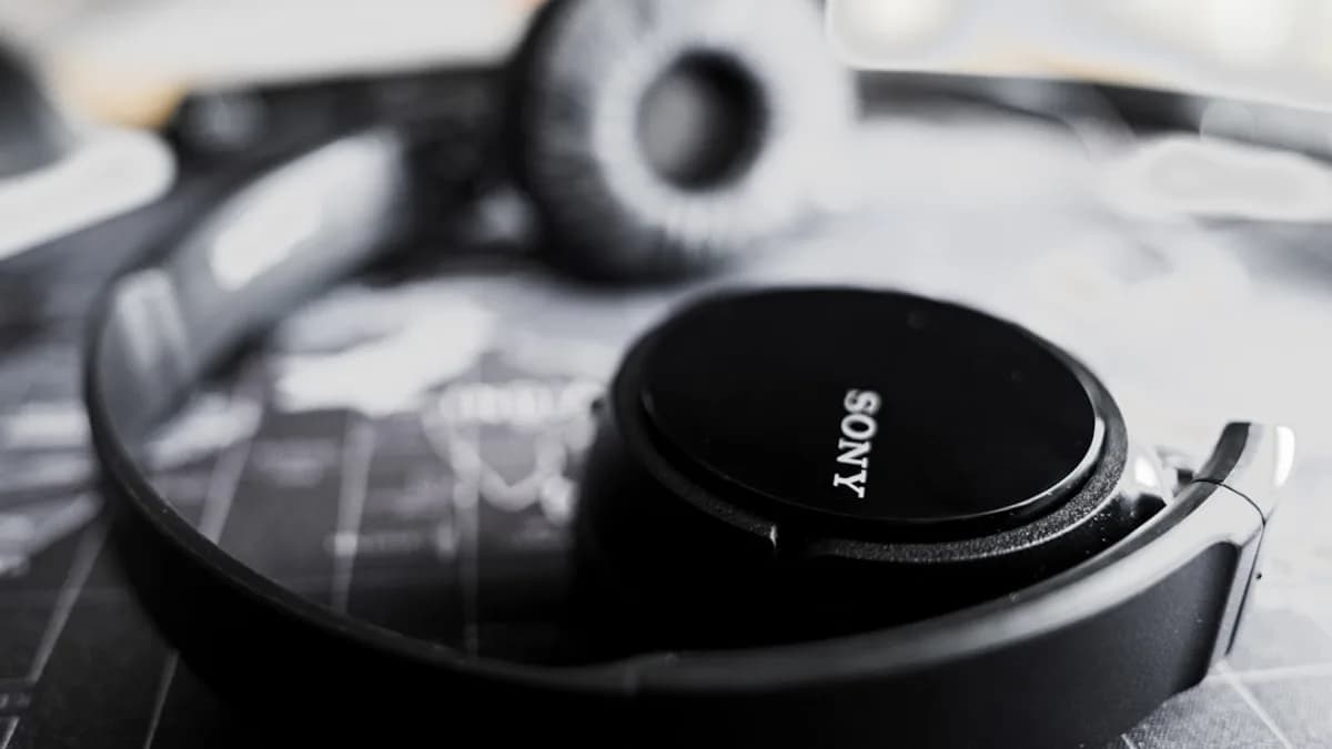 Black sony headphones resting on a surface.