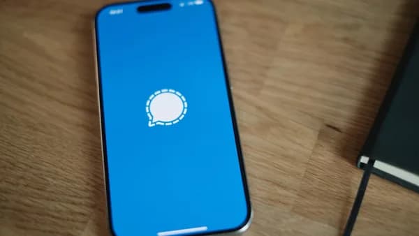 A cell phone sitting on top of a wooden table