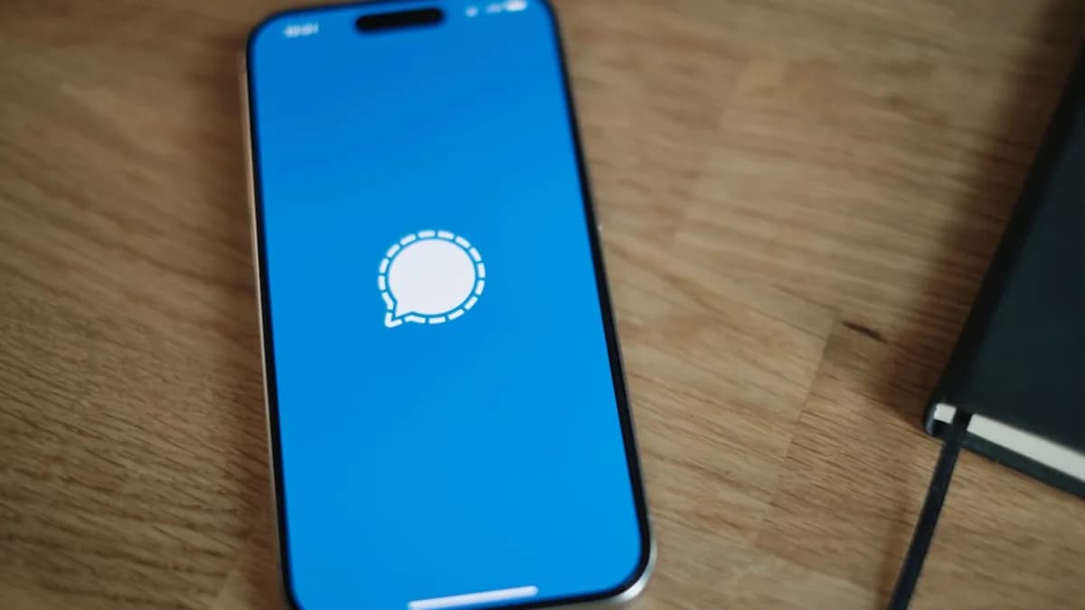 A cell phone sitting on top of a wooden table