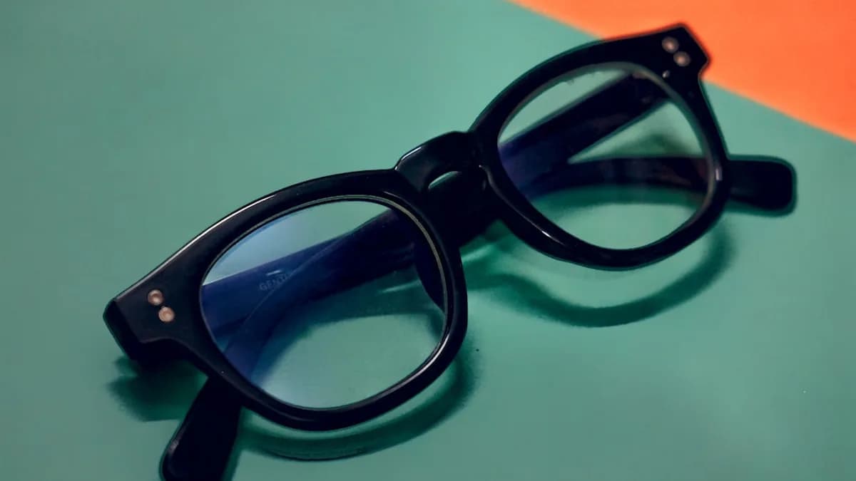 a pair of glasses sitting on top of a table
