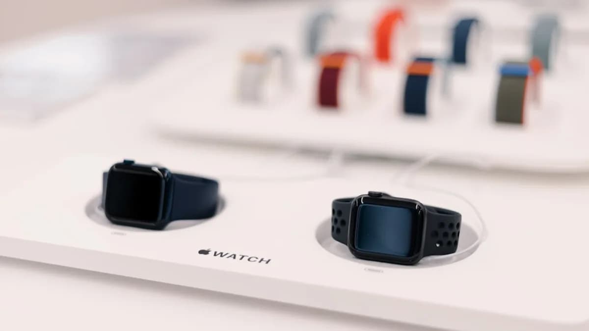 a couple of smart watches sitting on top of a table