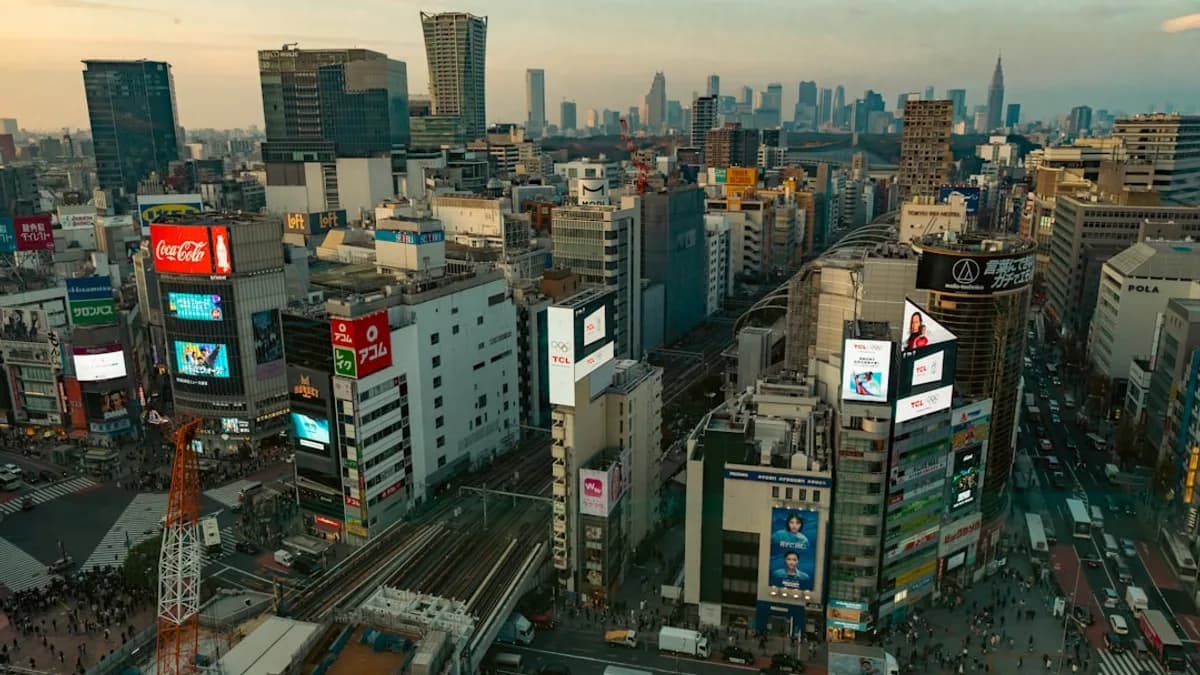 Busy cityscape with tall buildings and bright billboards.