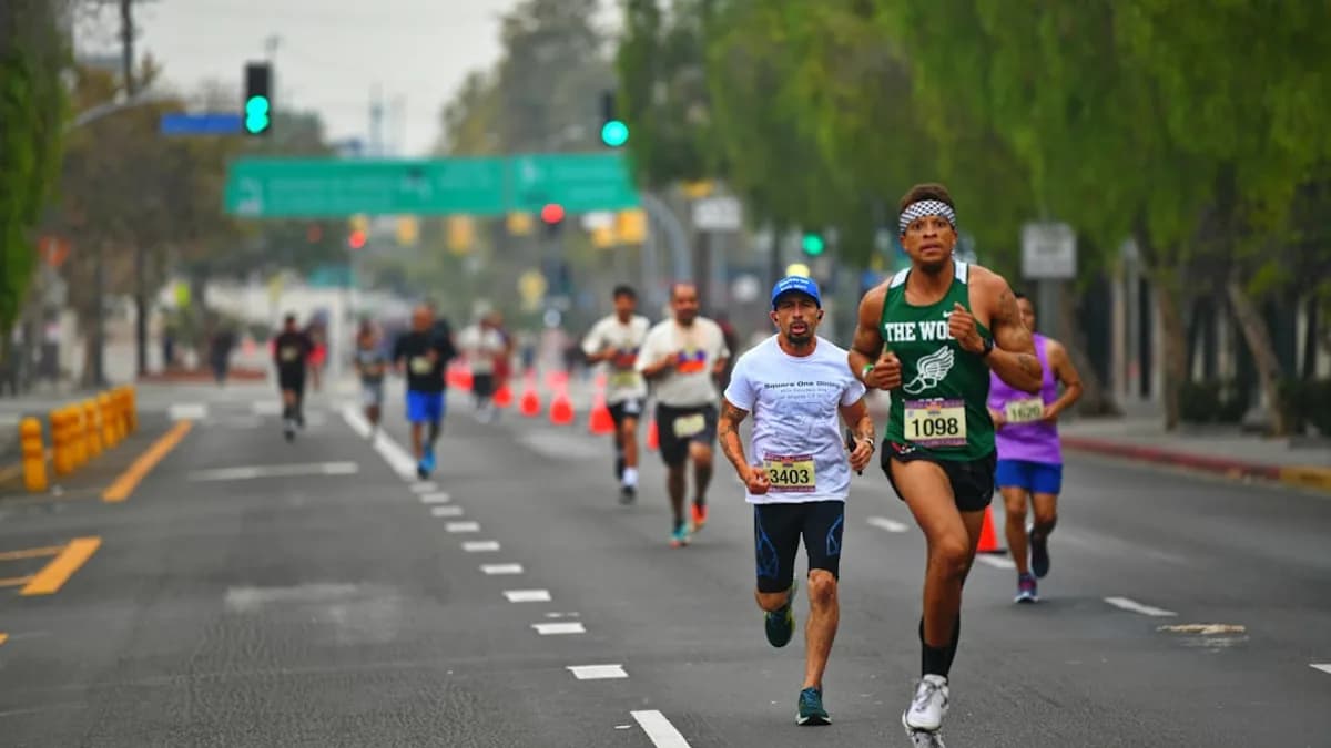 a group of people running down a street
