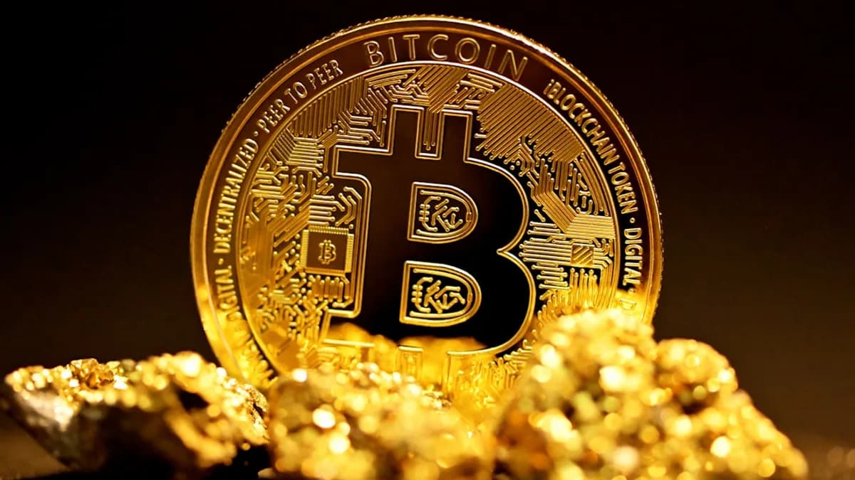 a bitcoin sitting on top of a pile of gold nuggets
