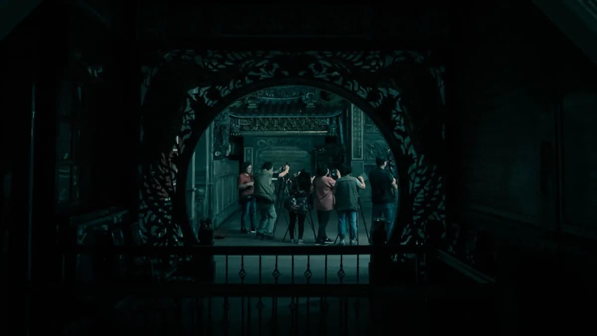 2 women standing in front of black metal gate