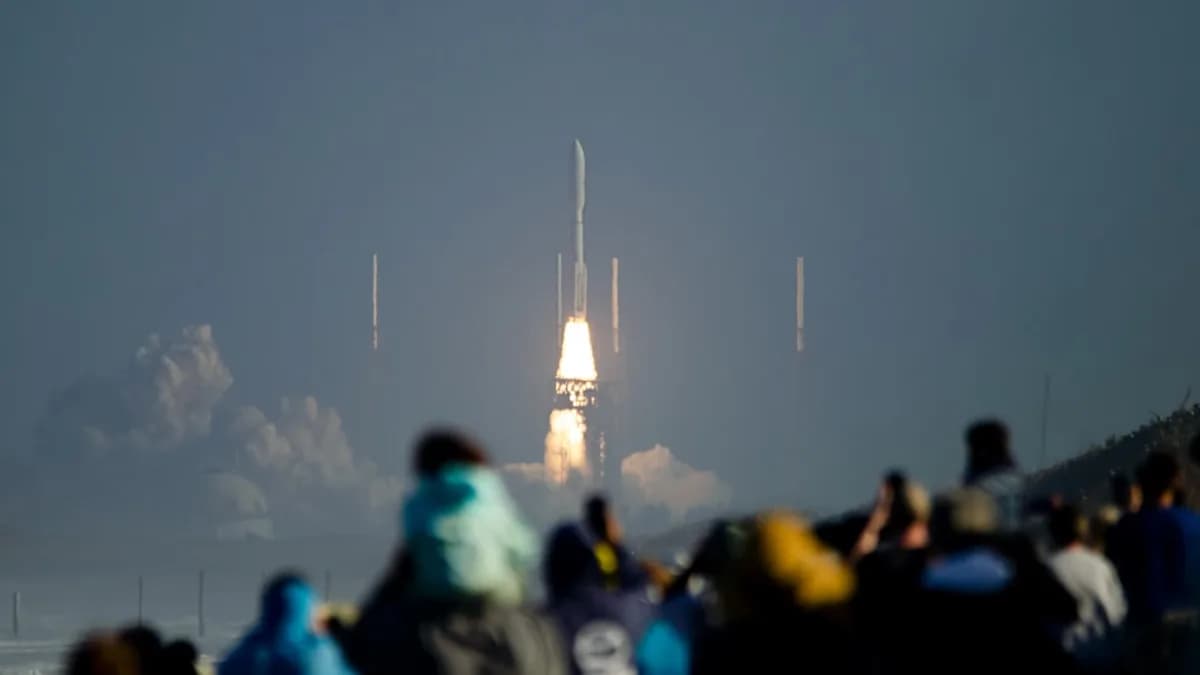 a crowd of people watching a rocket launch