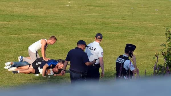 group of people sitting on green grass field during daytime