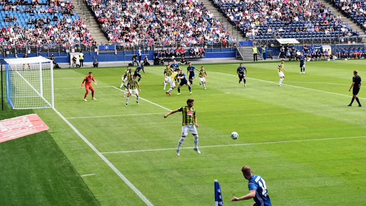 men playing soccer of soccer field during daytime
