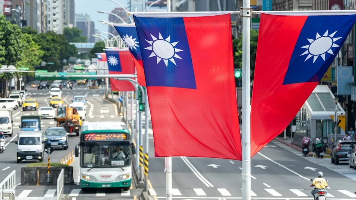 Taiwanese flags fly above a busy city street.