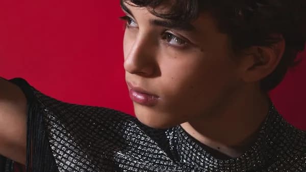 a close up of a person with a red background