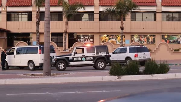 two police cars parked on the side of the road