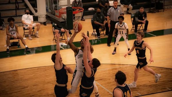 basketball players playing on basketball court
