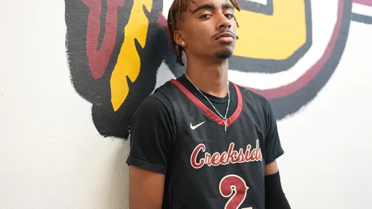 a man standing in front of a wall with a painting on it