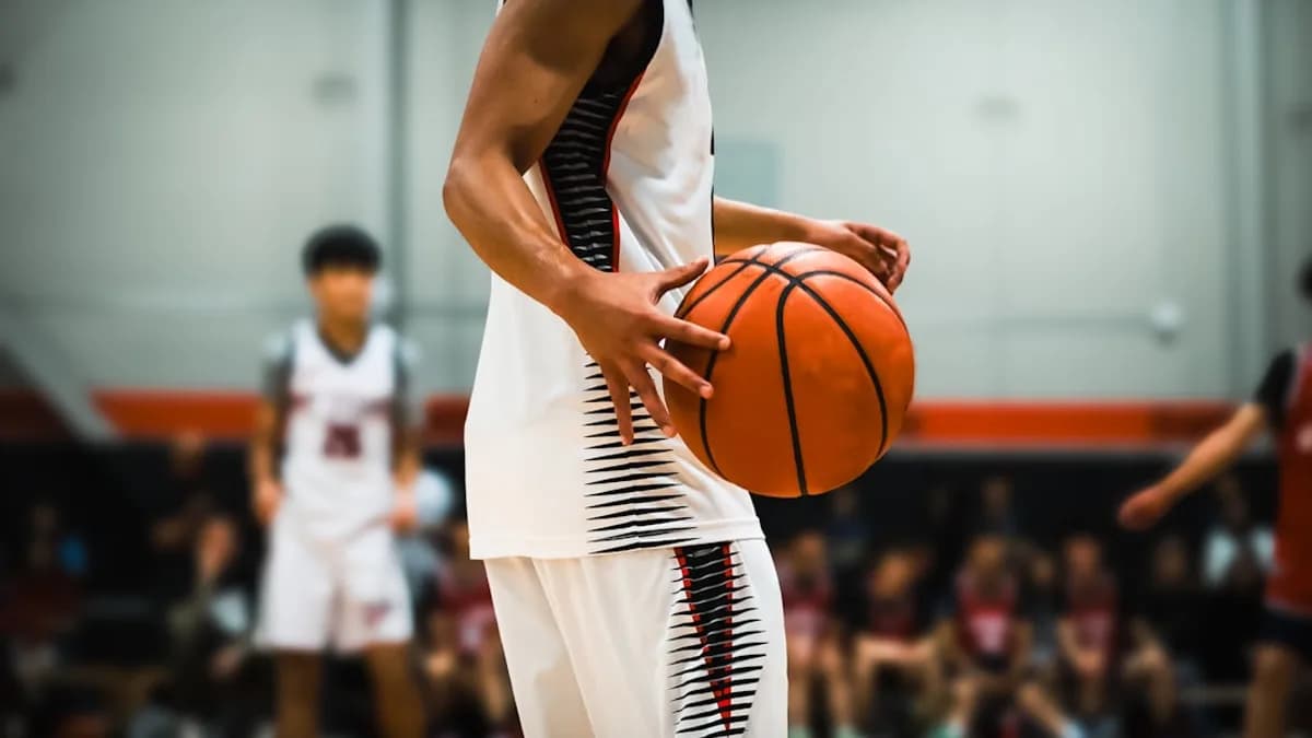 Basketball player holding the ball on the court.