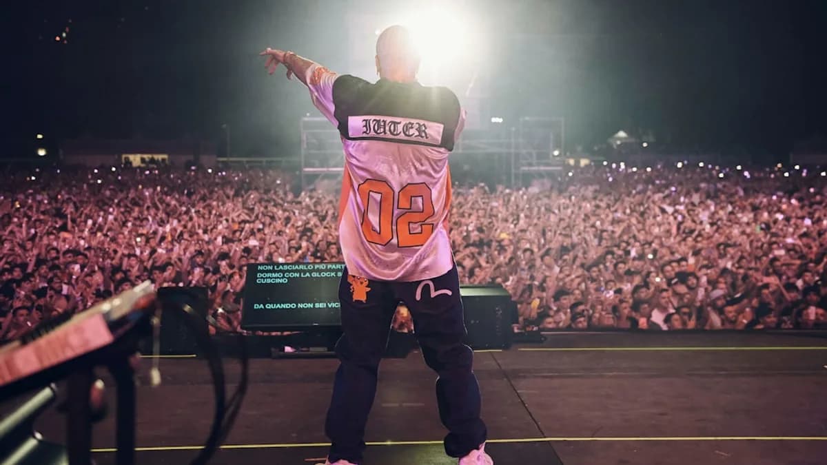 A man standing on top of a stage in front of a crowd