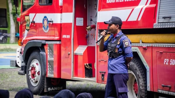 A fireman standing in front of a fire truck