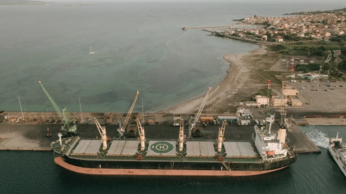 a large cargo ship in the water next to a dock