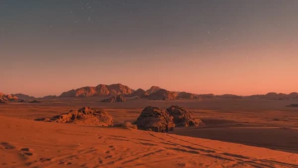 brown sand under blue sky during night time
