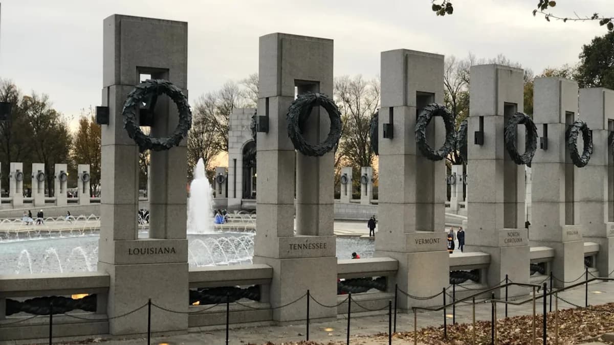 a group of cement pillars with wreaths on them