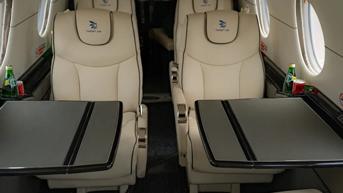 Luxurious interior of a private jet with plush seating.