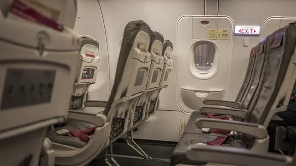 Empty airplane cabin with rows of seats