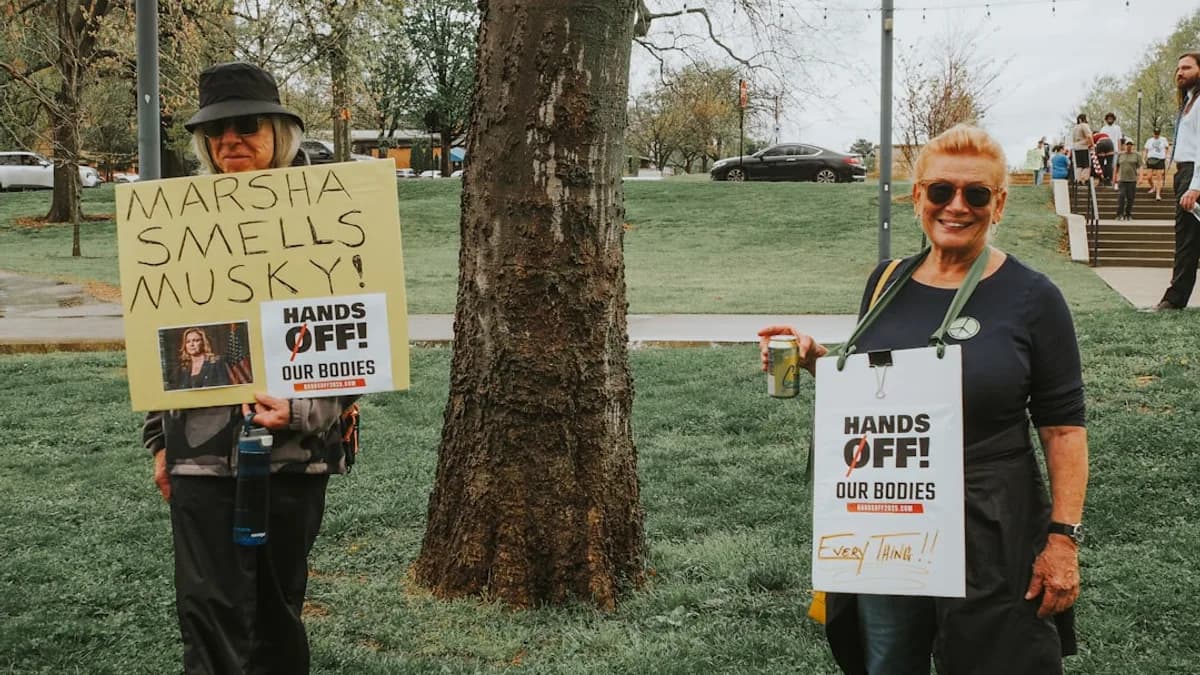 People protest with signs about bodily autonomy.