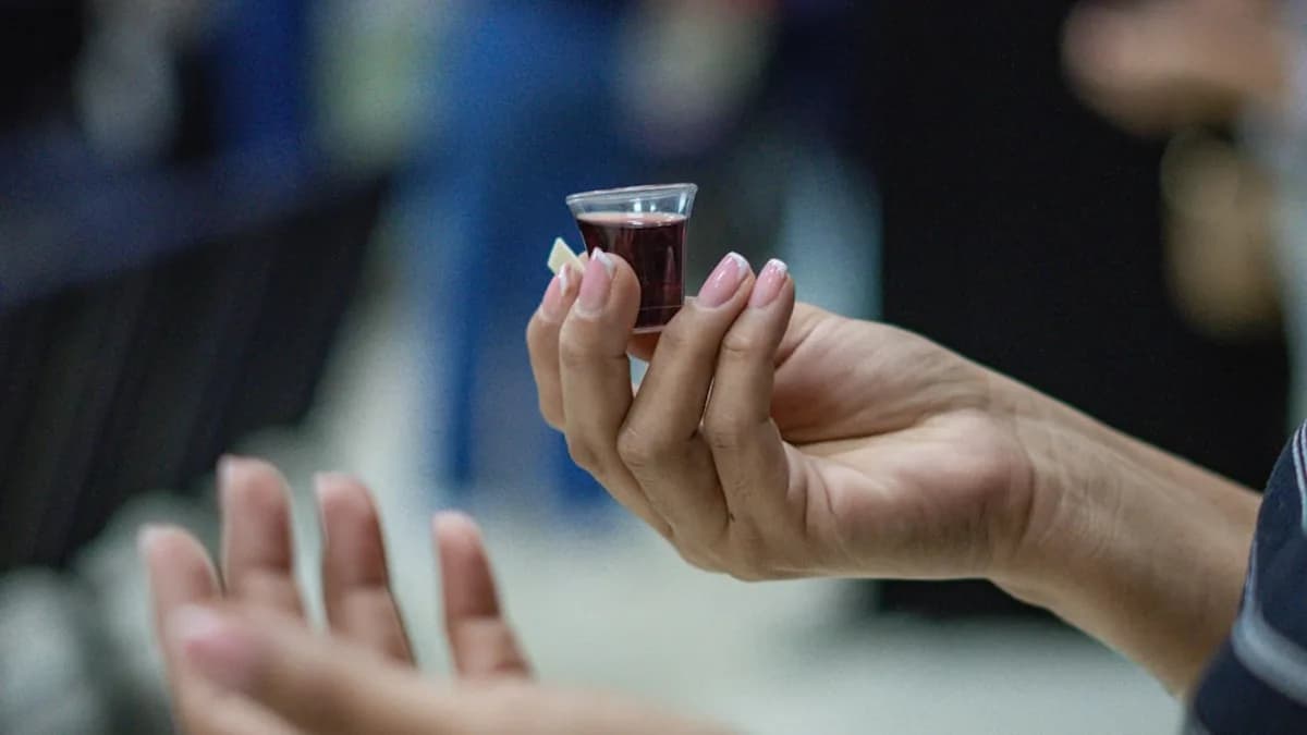 a woman holding a glass of wine in her hand