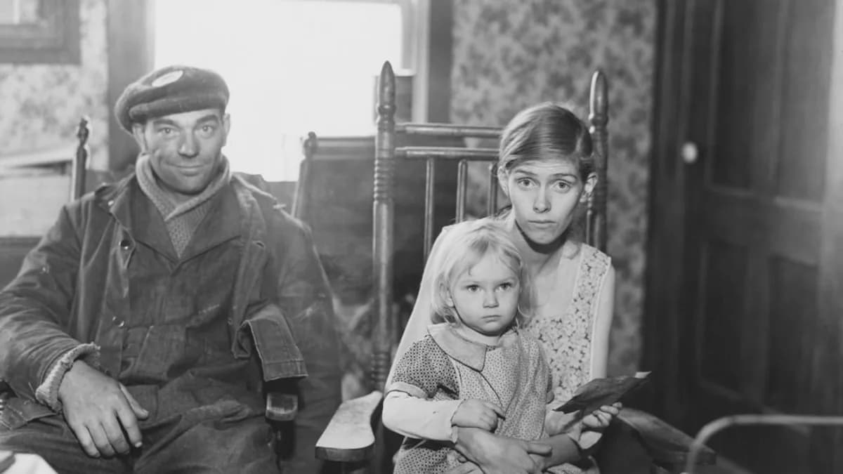 Man, woman, and child sit in rocking chairs.