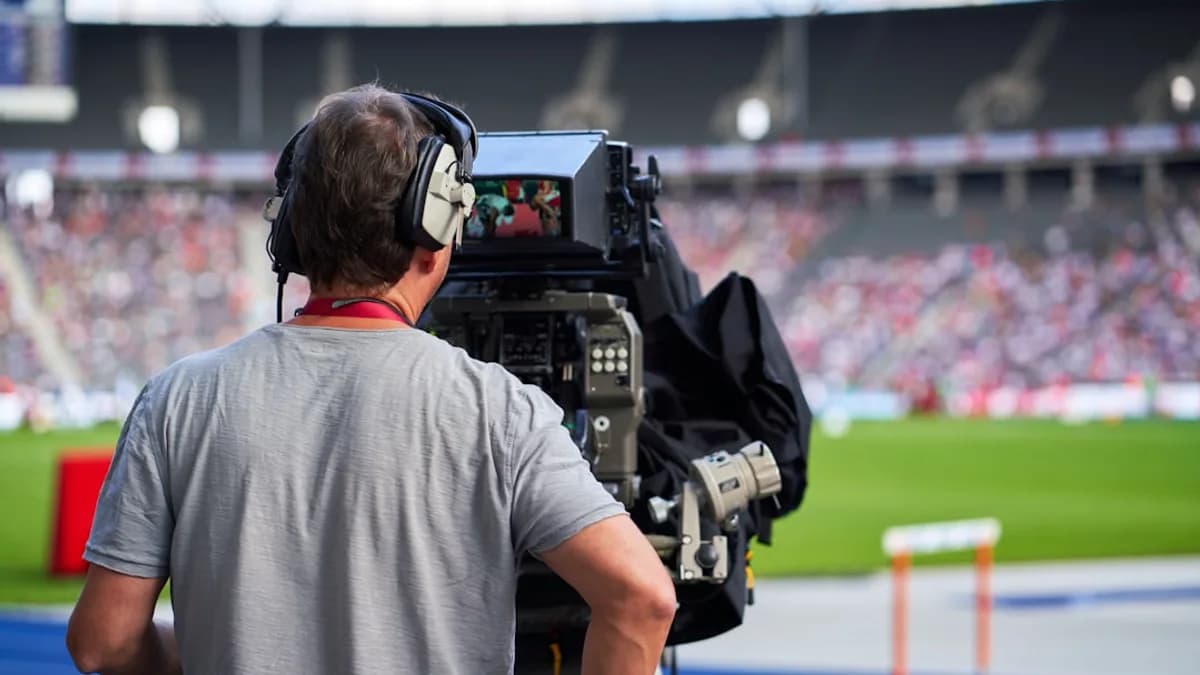 a man with headphones on sitting in front of a camera