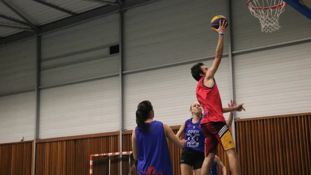 a group of young men playing a game of basketball