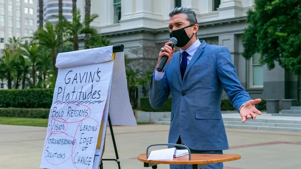 man in blue suit jacket holding white printer paper