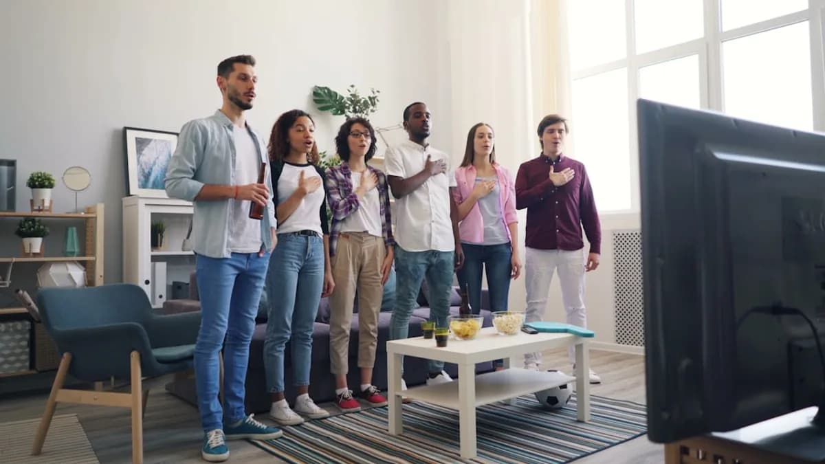a group of people standing in front of a tv