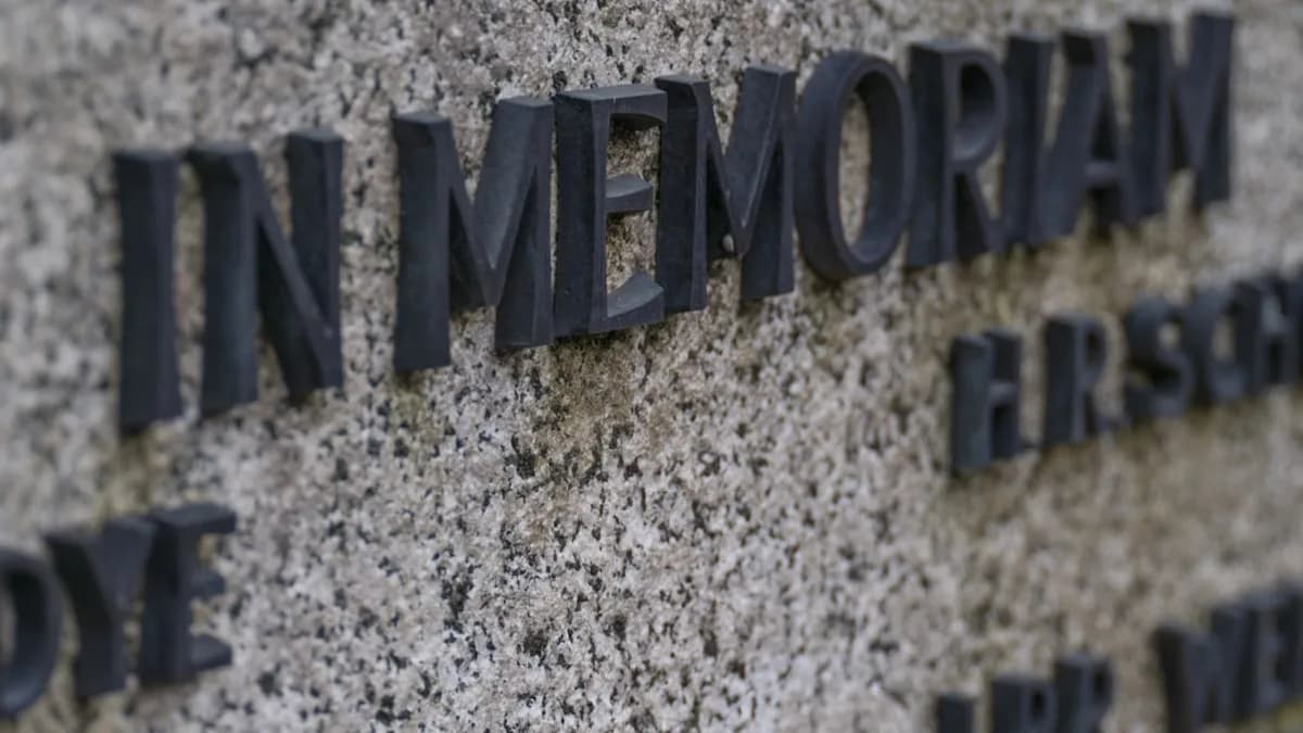 In memoriam text on a granite memorial wall.