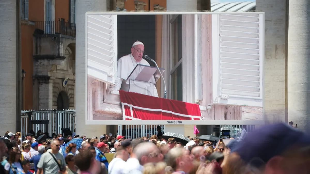 The pope is speaking to a large crowd.