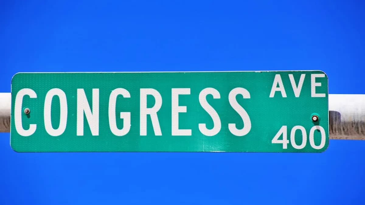 a close up of a street sign with a sky background