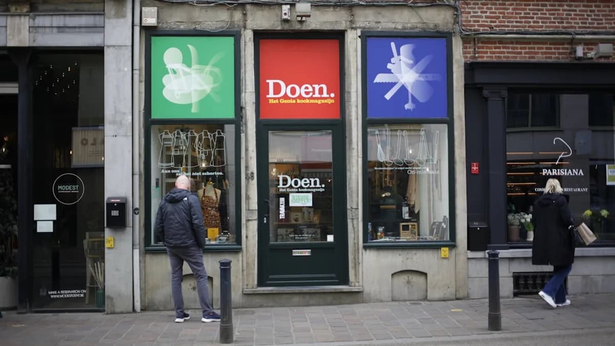 A shopfront with colorful signage and people.