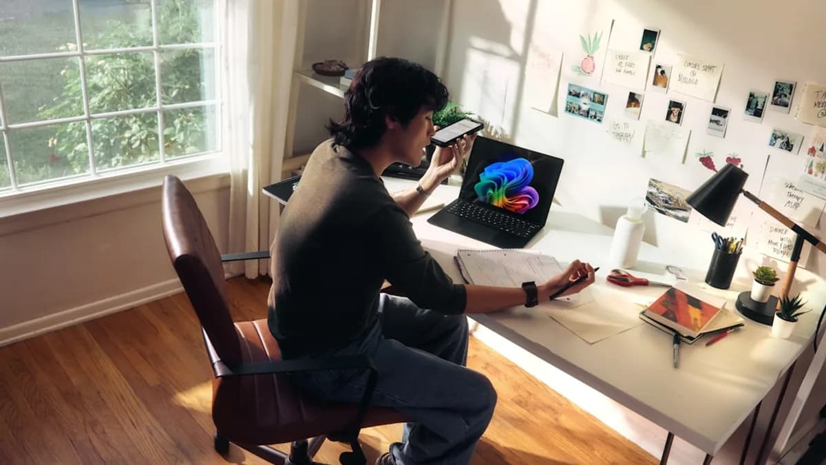 Person working at a desk with a laptop and books.
