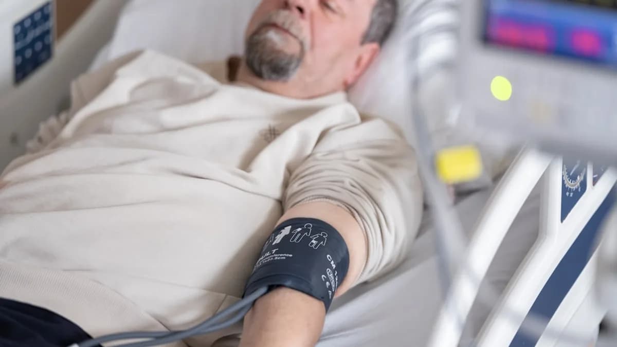 a man laying in a hospital bed with an iv
