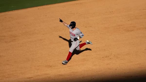 A baseball player running on a baseball field