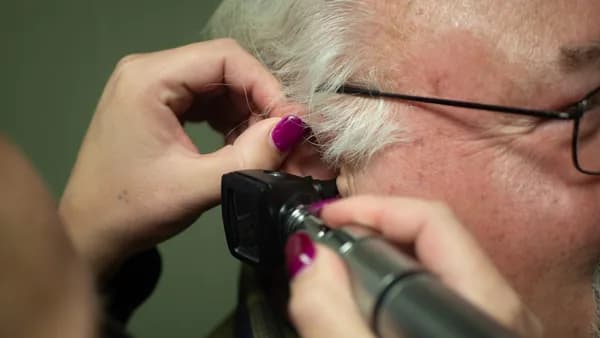 a person holding a phone to the ear