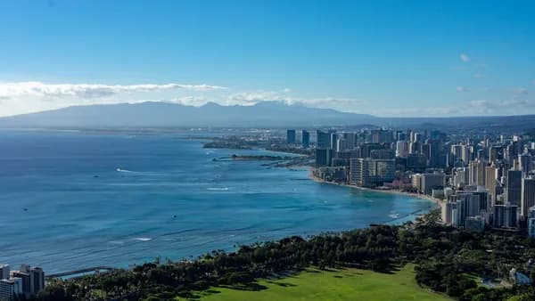 green grass field near body of water during daytime