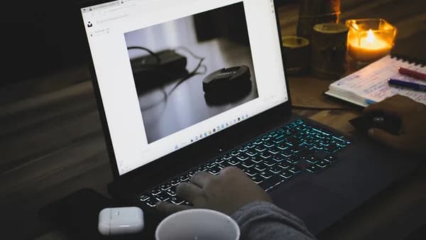 a person sitting in front of a laptop computer
