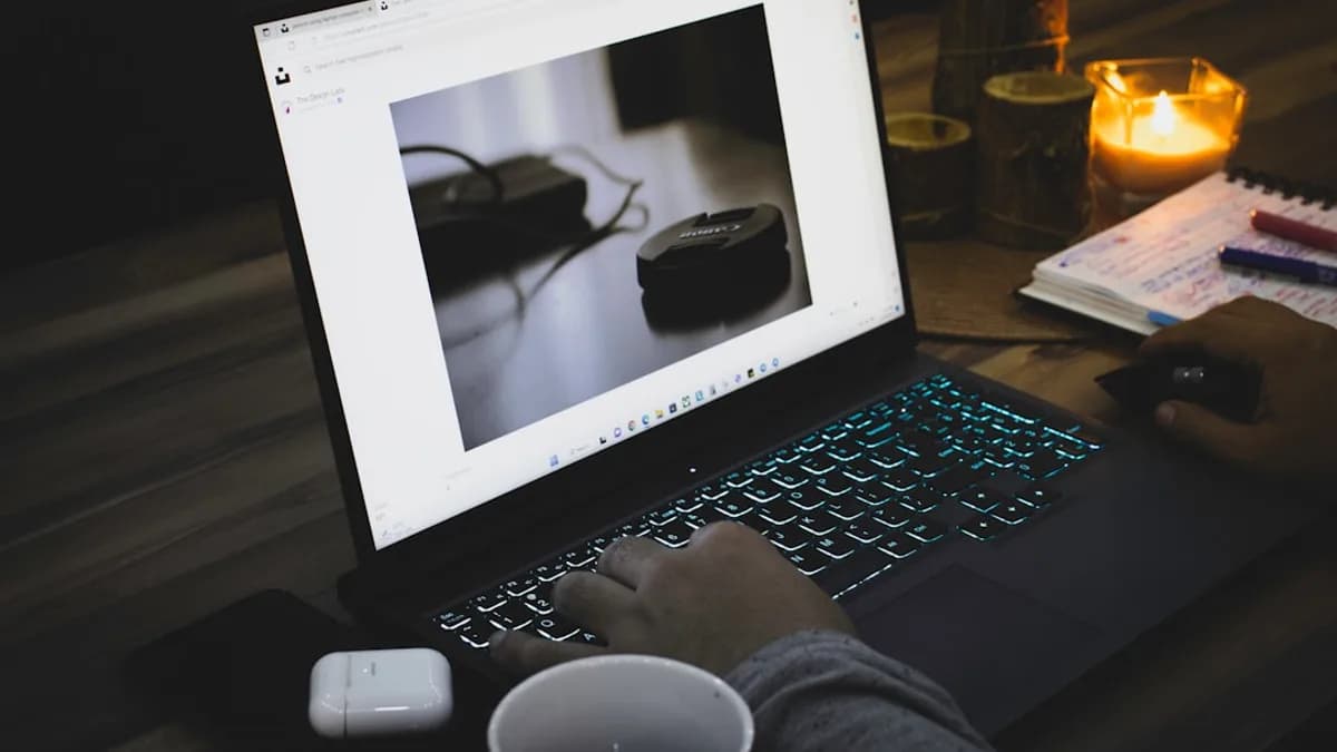 a person sitting in front of a laptop computer