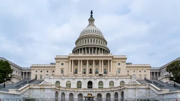 A large building with a fountain in front of it