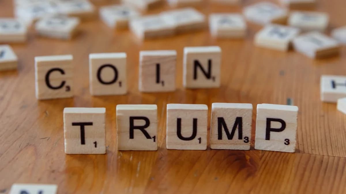 Scrabble letters spelling the word coin trump on a wooden table