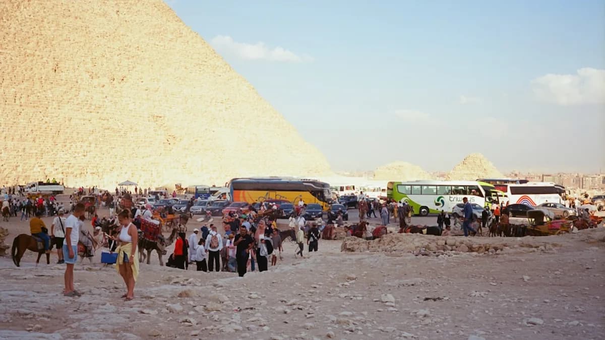 Tourists gather near the great pyramid in egypt.
