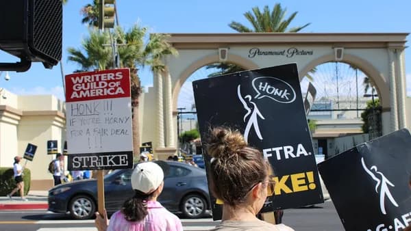 a group of people holding protest signs on a city street