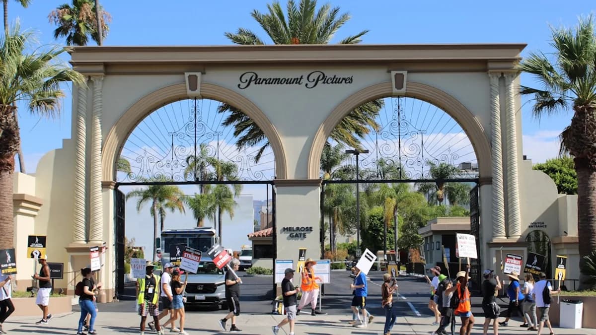 a group of people holding signs in front of a building