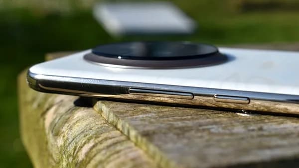 Close-up of a white smartphone with a circular camera lens.