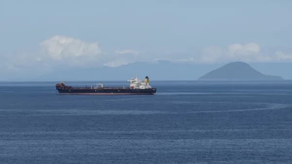 a large cargo ship in the middle of the ocean